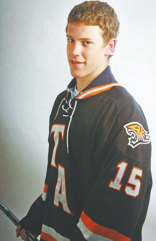 Charlie Coyle holding a hockey stick during his time as a high school player, Stanley Cup